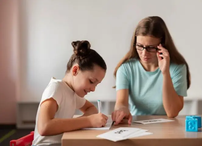 Psychologist helping girl in Speech Therapy