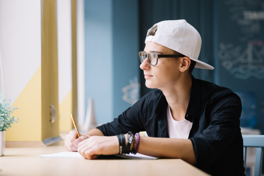 Student Posing Pensively in Classroom thinking over his Future