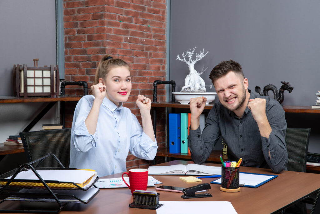 Satisfied Management Team sitting on the Table in the Office Meeting Room