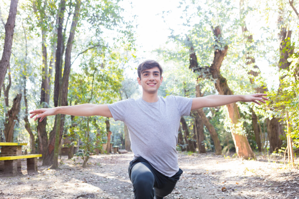 Active guy Stretching his Arms Outdoors