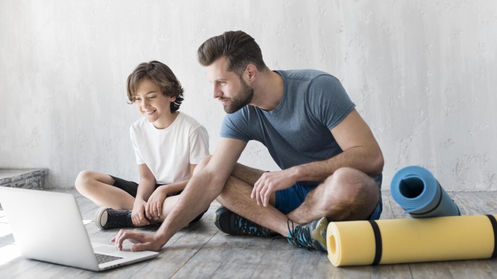 Father with his Kid doing Sports at Home