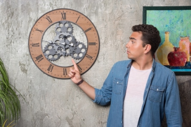 Youngman Pointing Clock Posing Marble Background