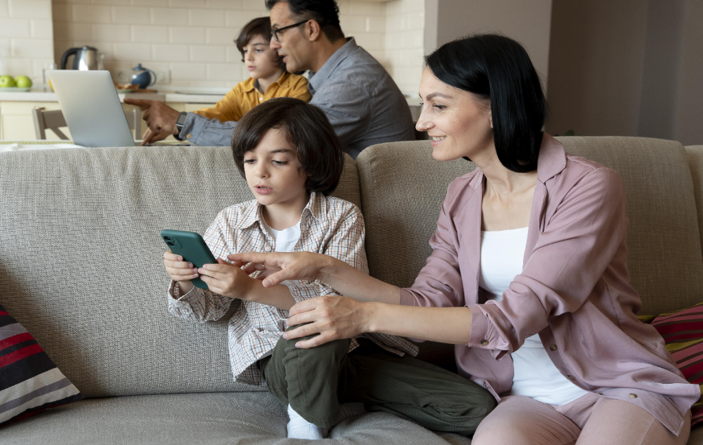 Cautious Mother wanting watch what her son is Playing on Phone Cautious Mother wanting to watch what her son is Playing on the phone