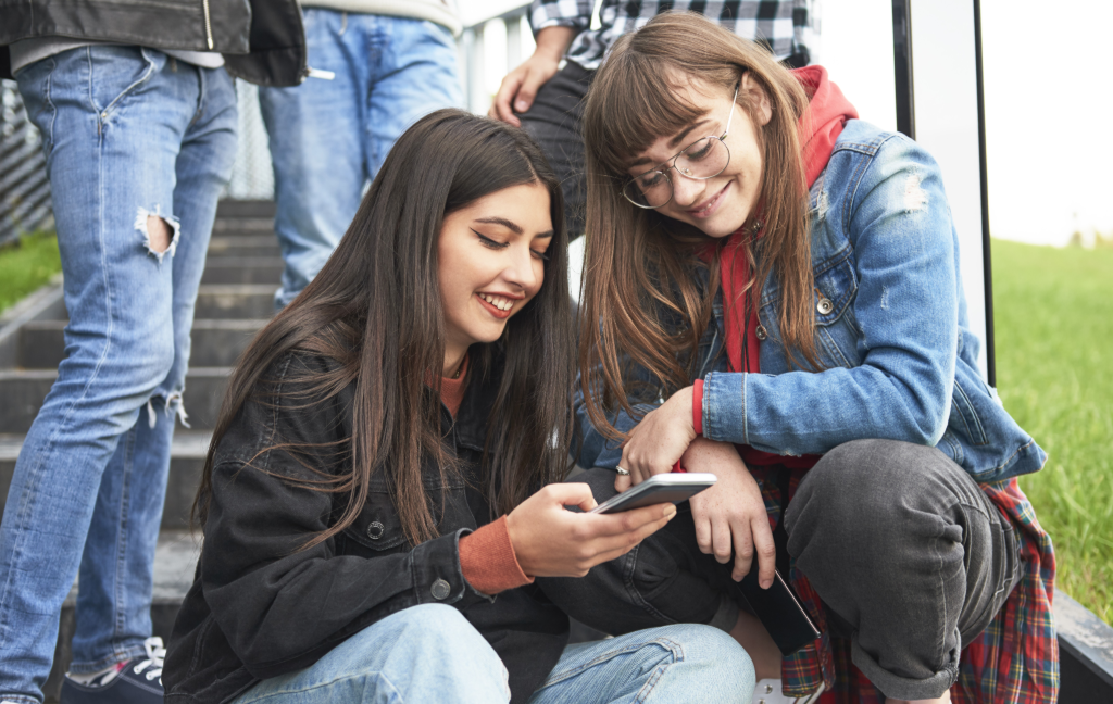 Two young women looking Mobile Phone Youngsters to take advantage of social media's creative contents